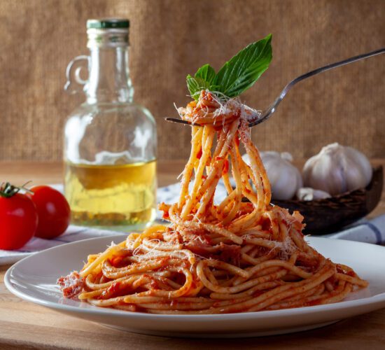 Spaghetti in a dish on a wooden background