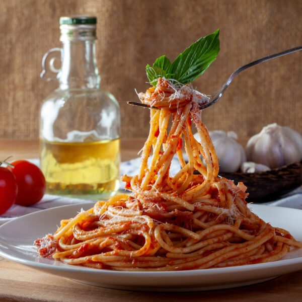 Spaghetti in a dish on a wooden background