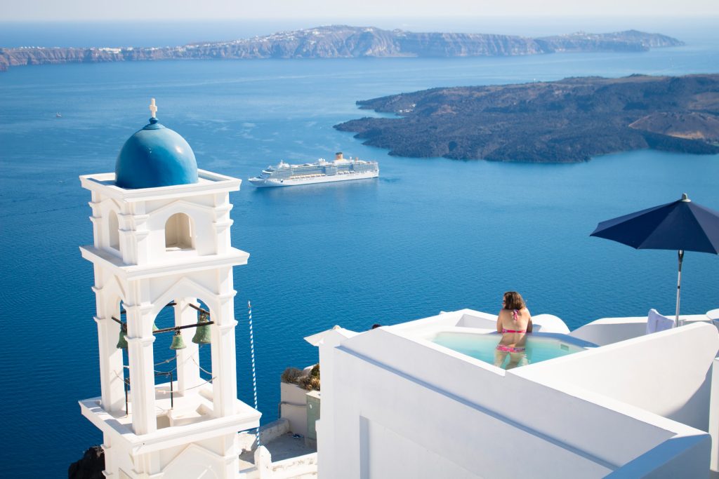 Best Tour Operators Us / A serene and picturesque view of Santorini, Greece, characterized by the iconic white architecture with blue domes.